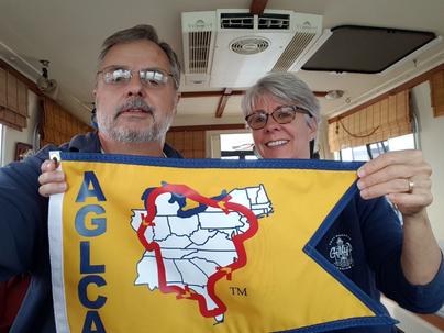 Couple on Boat Holding Boat Flag
