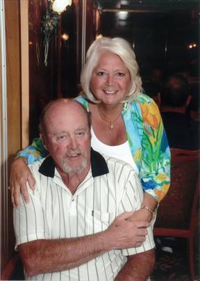 Couple Standing Together With Arms Around One Another