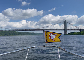 Burgee Flying on Boat Approaching Bridge