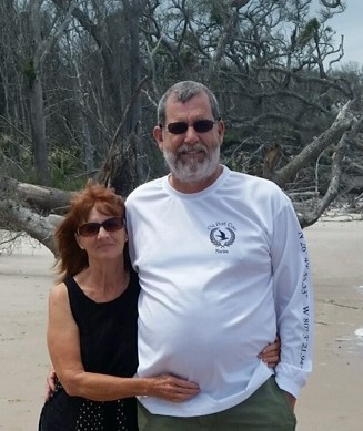 Couple Standing Together With Arms Around One Another